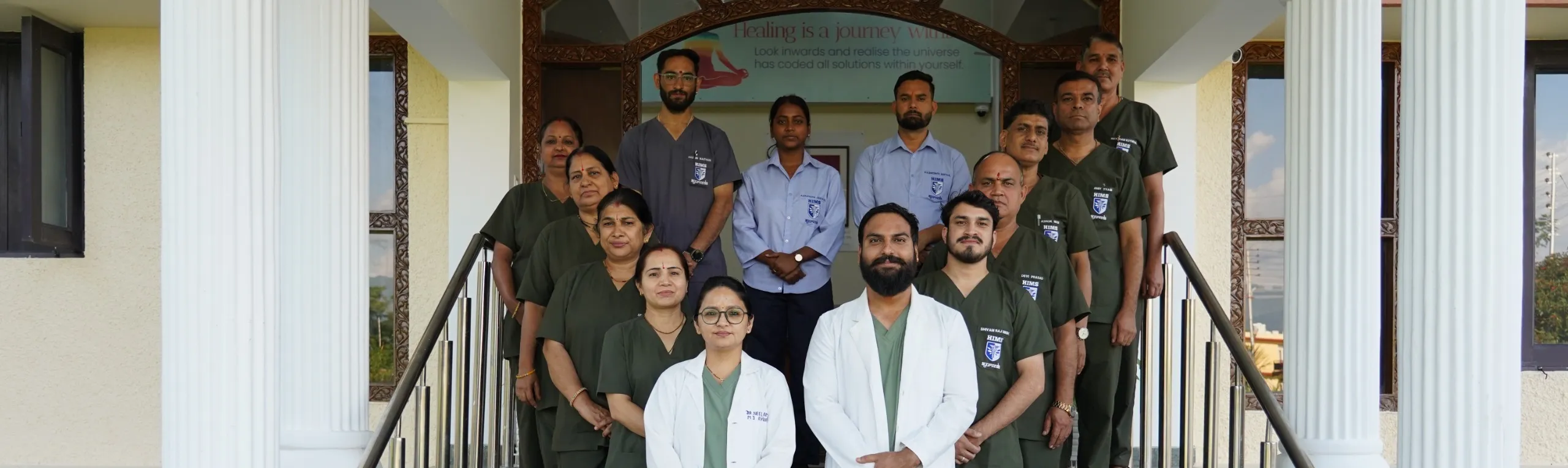 The Ayurveda Centre care team: vaidyas, therapists and staff on the steps of the centre